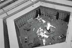 A plane crash is simulated inside the cardboard courtyard of a model Pentagon.