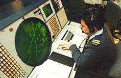 A soldier monitors a NORAD radar screen.